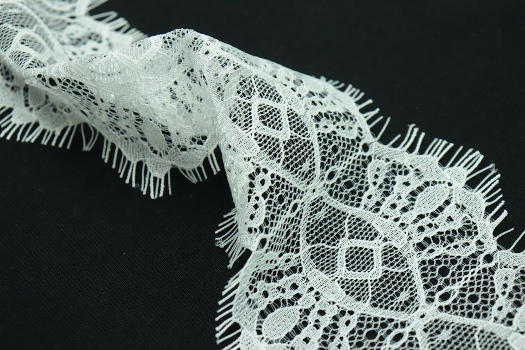 portfolio-04 a-close-up-of-a-white-lace-on-a-black-background-rwn2d8dcvxu